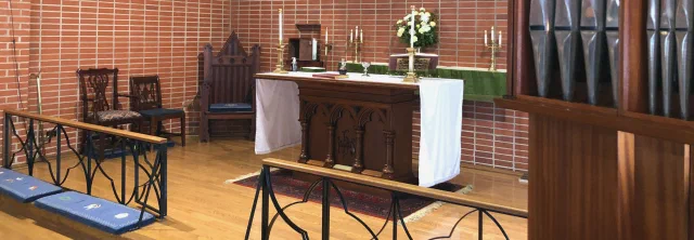 The altar at St. Andrew's, with the chancel cross and candles